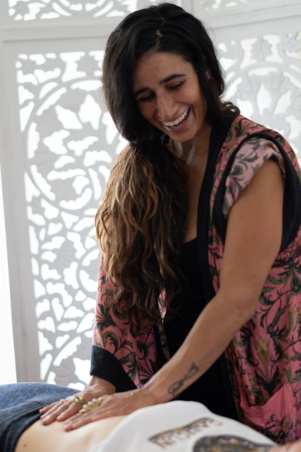 Practitioner smiling while working with a client
