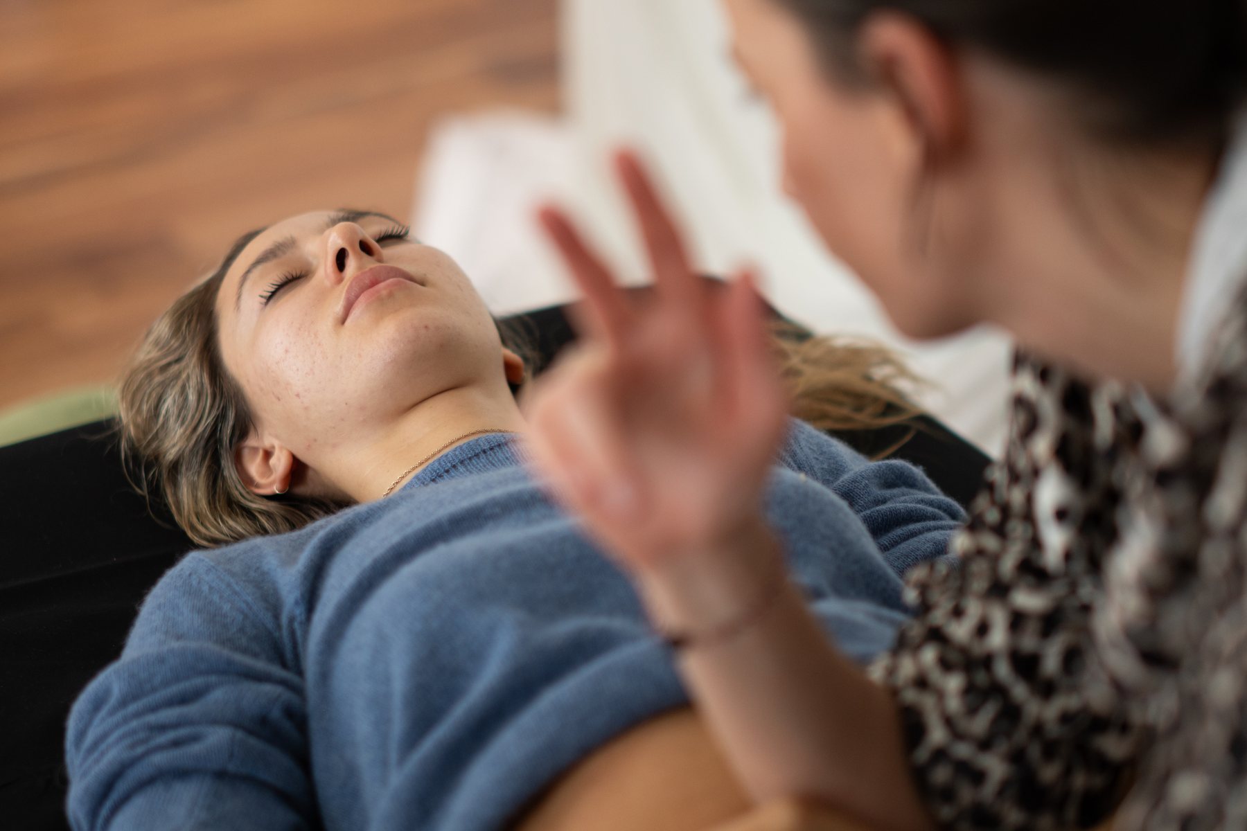 Practitioner mid-gesture during bodywork